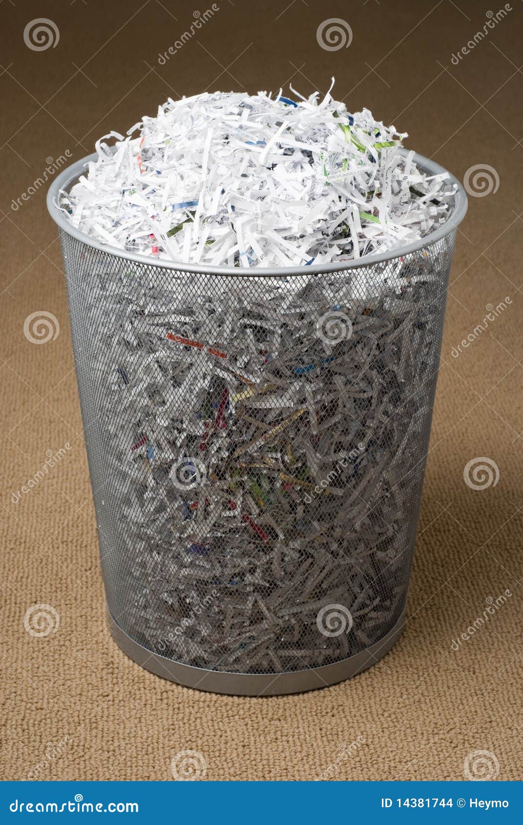 wastepaper basket filled with shredded paper