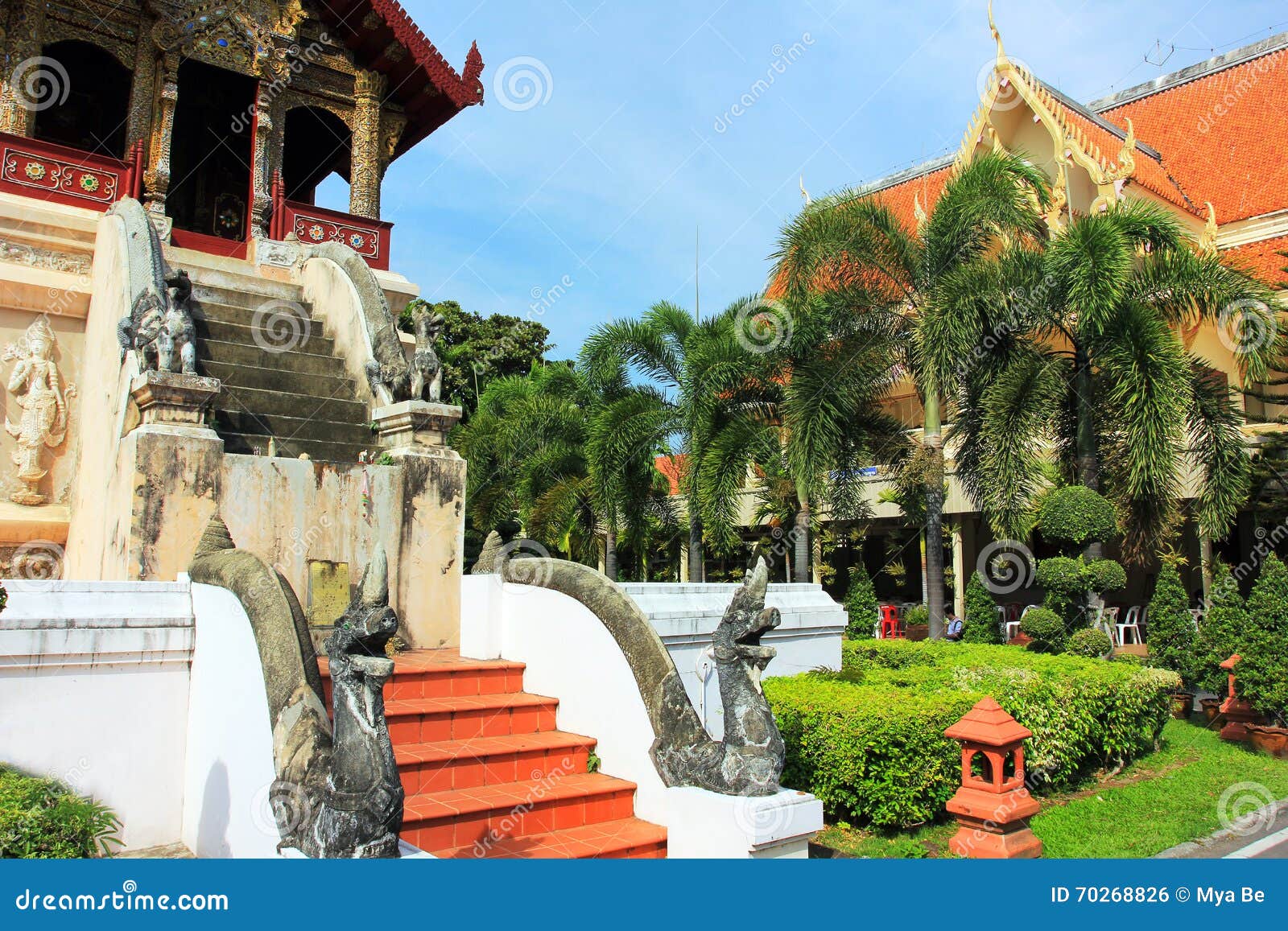 Wat Chiang Man buddhist temple, Chiang Mai Thailand. The Wat Phan Tao buddist oldest temple in Chiang Mai, ThaÃ¯land, East Asia. green trees, golden colored lamps and other decorations, plants, flowers, some temple buildings, dragon and elephant statues, daylight, sunny day, blue sky