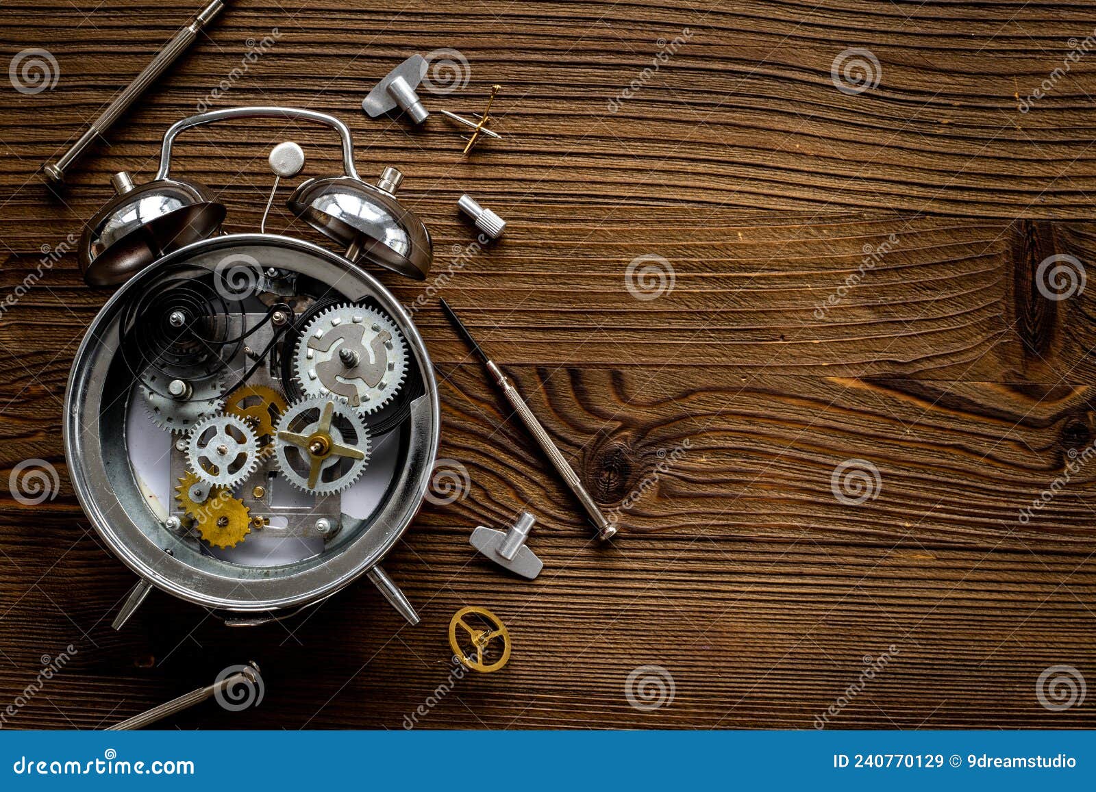 Watch Mechanism and Watchmaker Tools Near Open Alarm Clock Stock Image