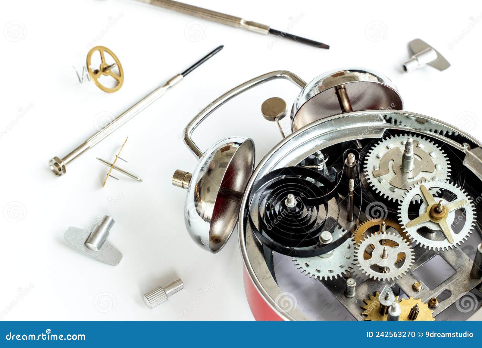 Watch Mechanism and Watchmaker Tools Near Open Alarm Clock Stock Photo