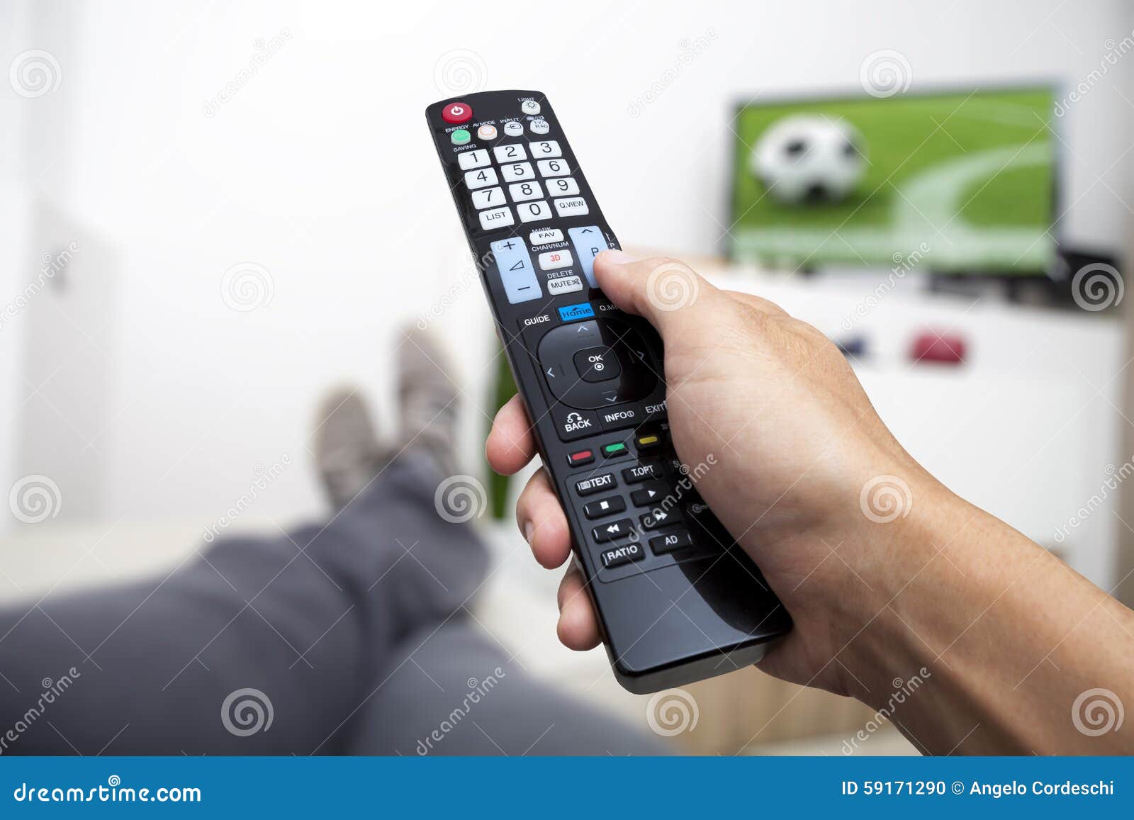 watching tv. remote control in hand. football