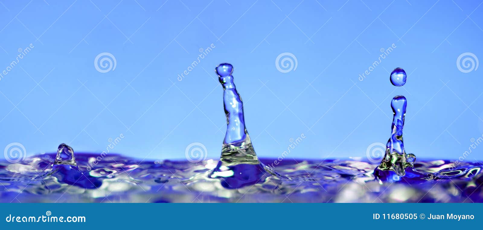 Three drops water on a blue background