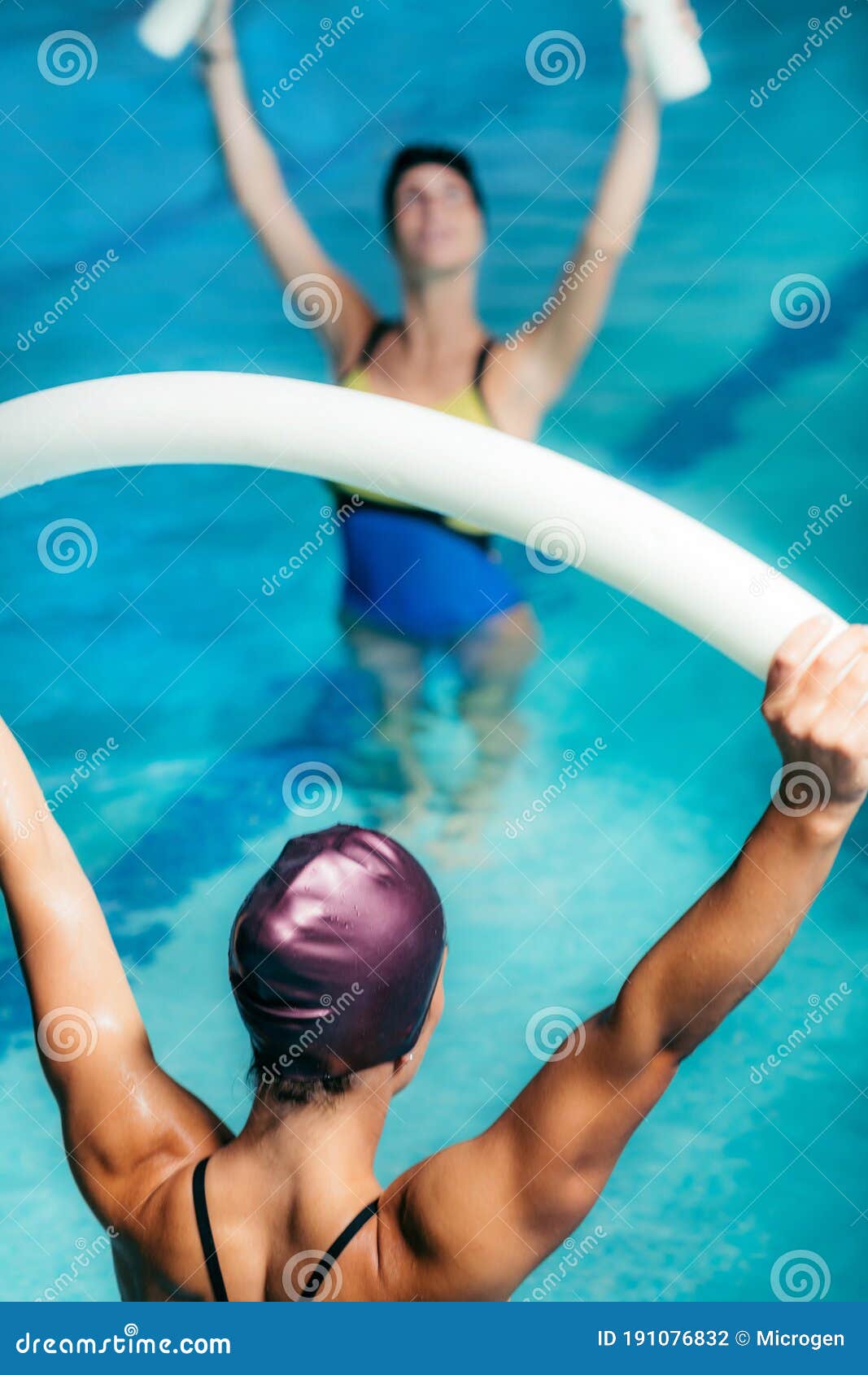 Water Aerobics Class, Group of Women Exercising with Instructor Stock