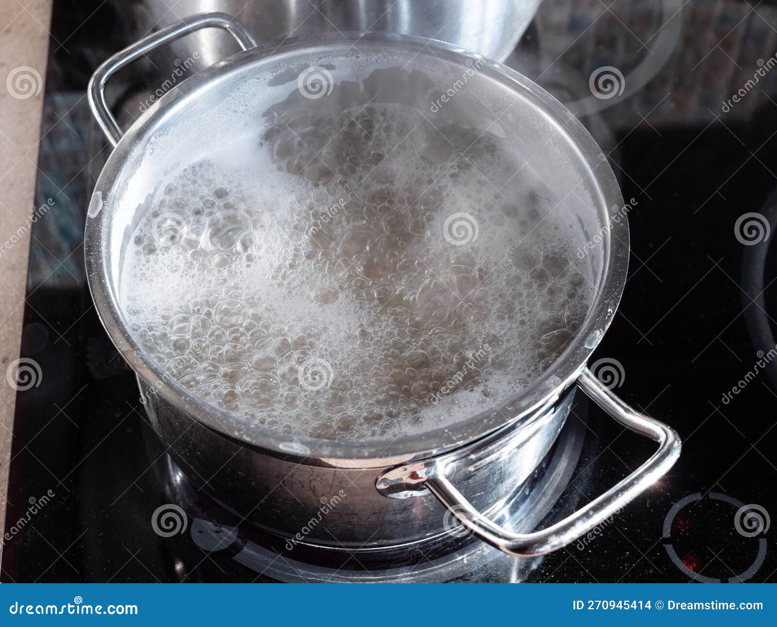 Water Boils in Steel Pan on Ceramic Stove at Home Stock Photo Image