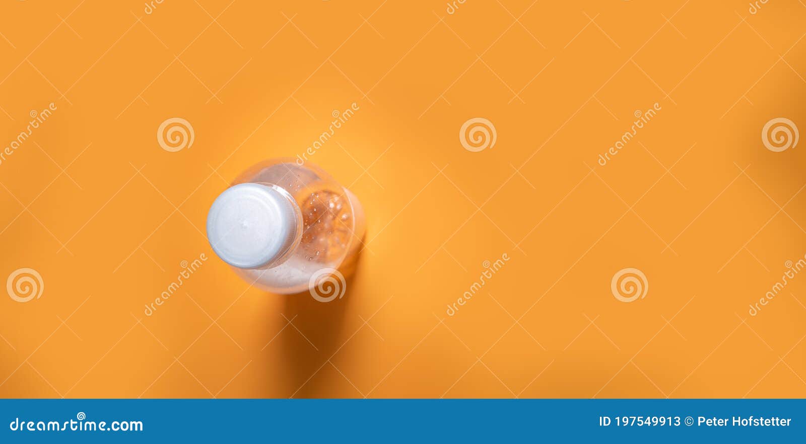 Water Bottle on Orange Background with Copy Space. Simplicity Stock