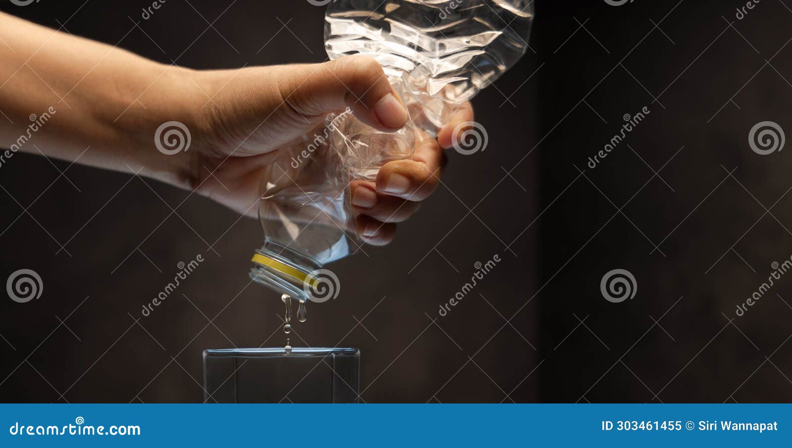 water crisis, climate change, el nino, global warming issue concept. hand trying to squeeze water from a bottle