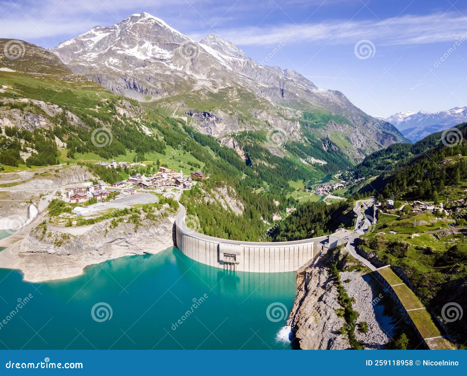 water dam and reservoir lake aerial view in alps mountains generating hydroelectricity. low co2 footprint, decarbonize, renewable