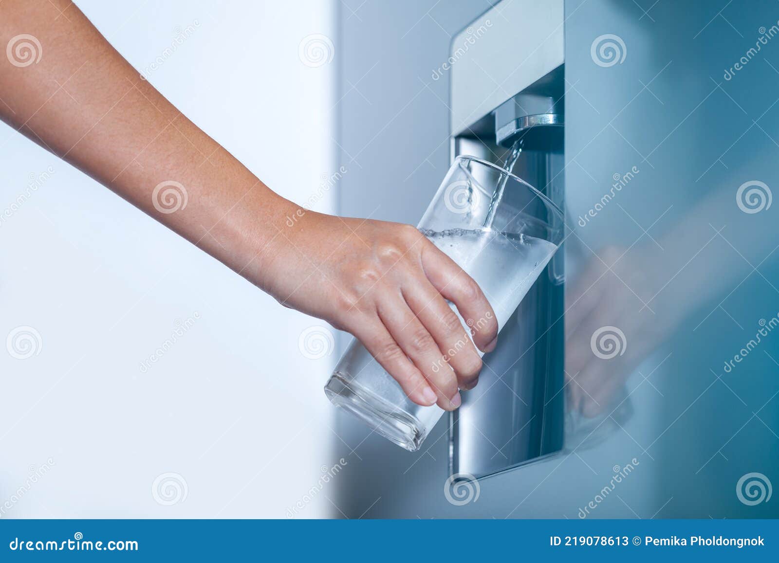 Water Dispenser from Dispenser of Home Fridge, Woman is Filling a