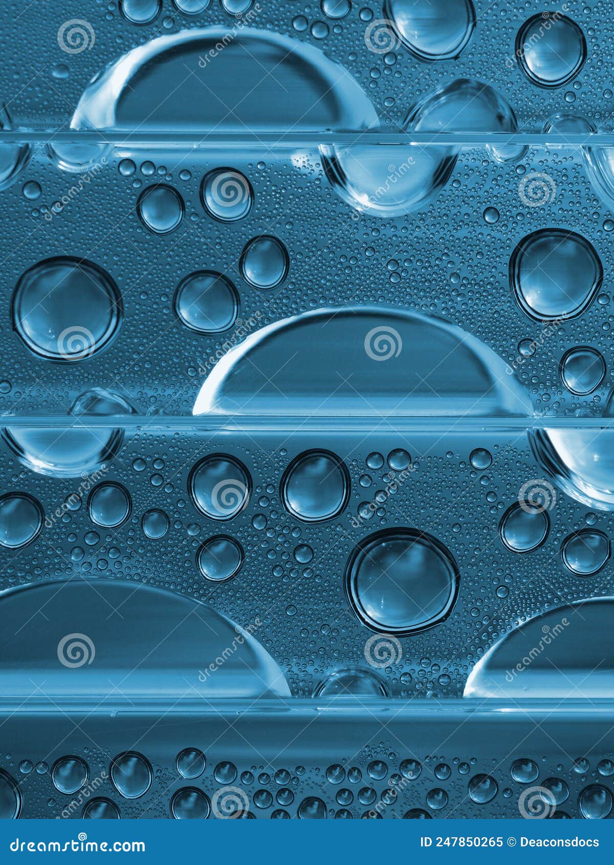 water drops close up. abstract aqua vertical background. blue tinted natural backdrop. strong macro
