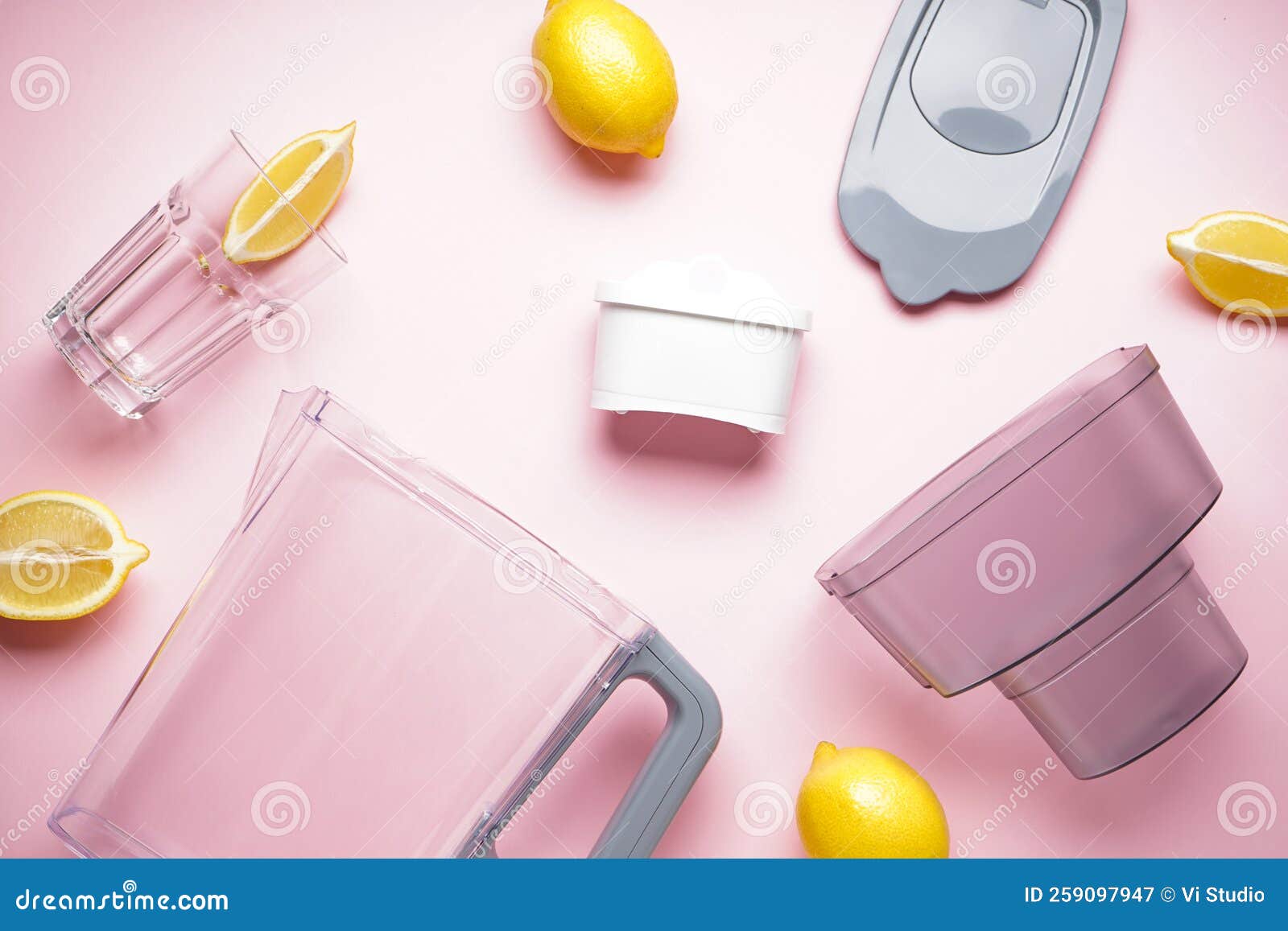 Water Filter Jug and Glass of Water with Lemon on a Pink Background