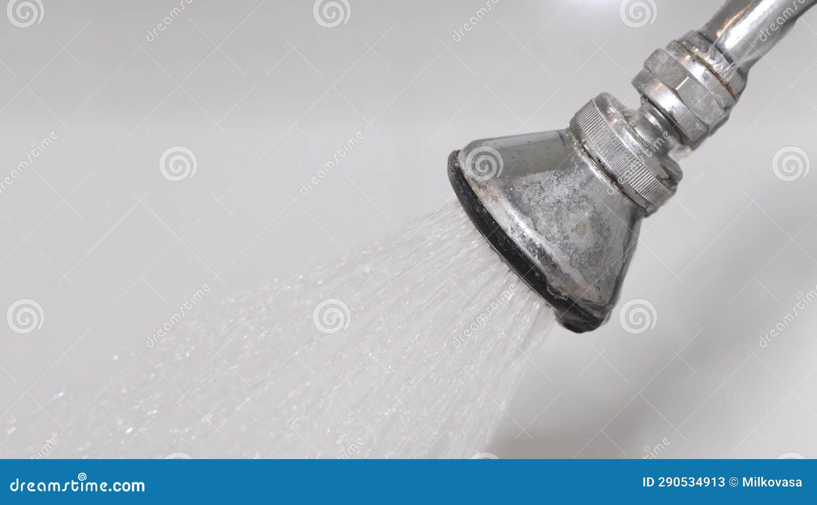 Water Flows from an Old Shower Head Fixed in the Bathroom Wall Stock