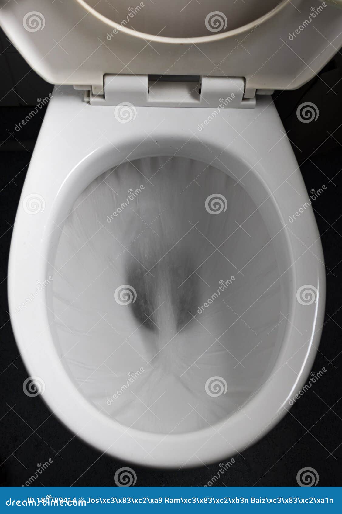 The Water Flows Through The Toilet Bowl Stock Photo
