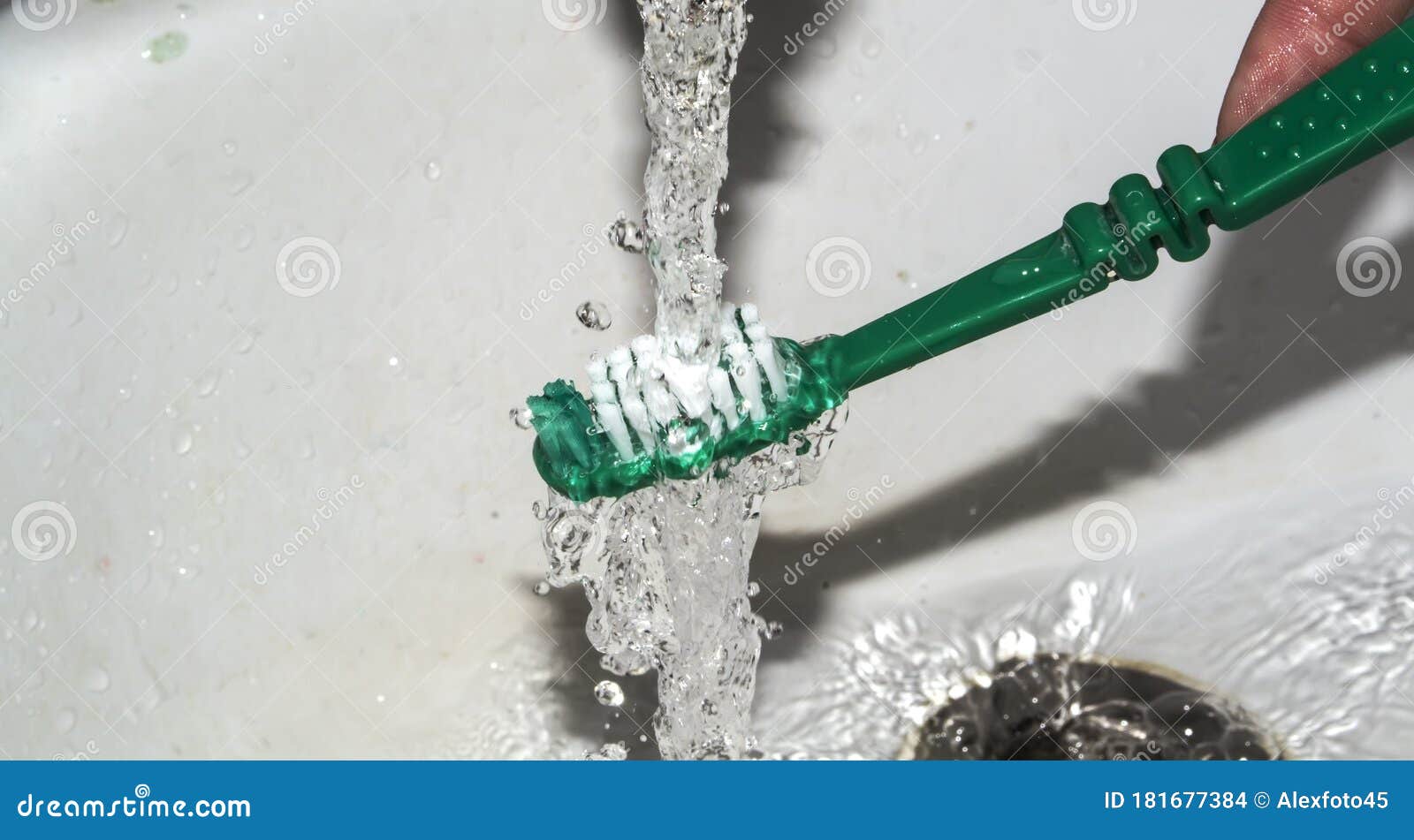 water flushes toothpaste from the brush