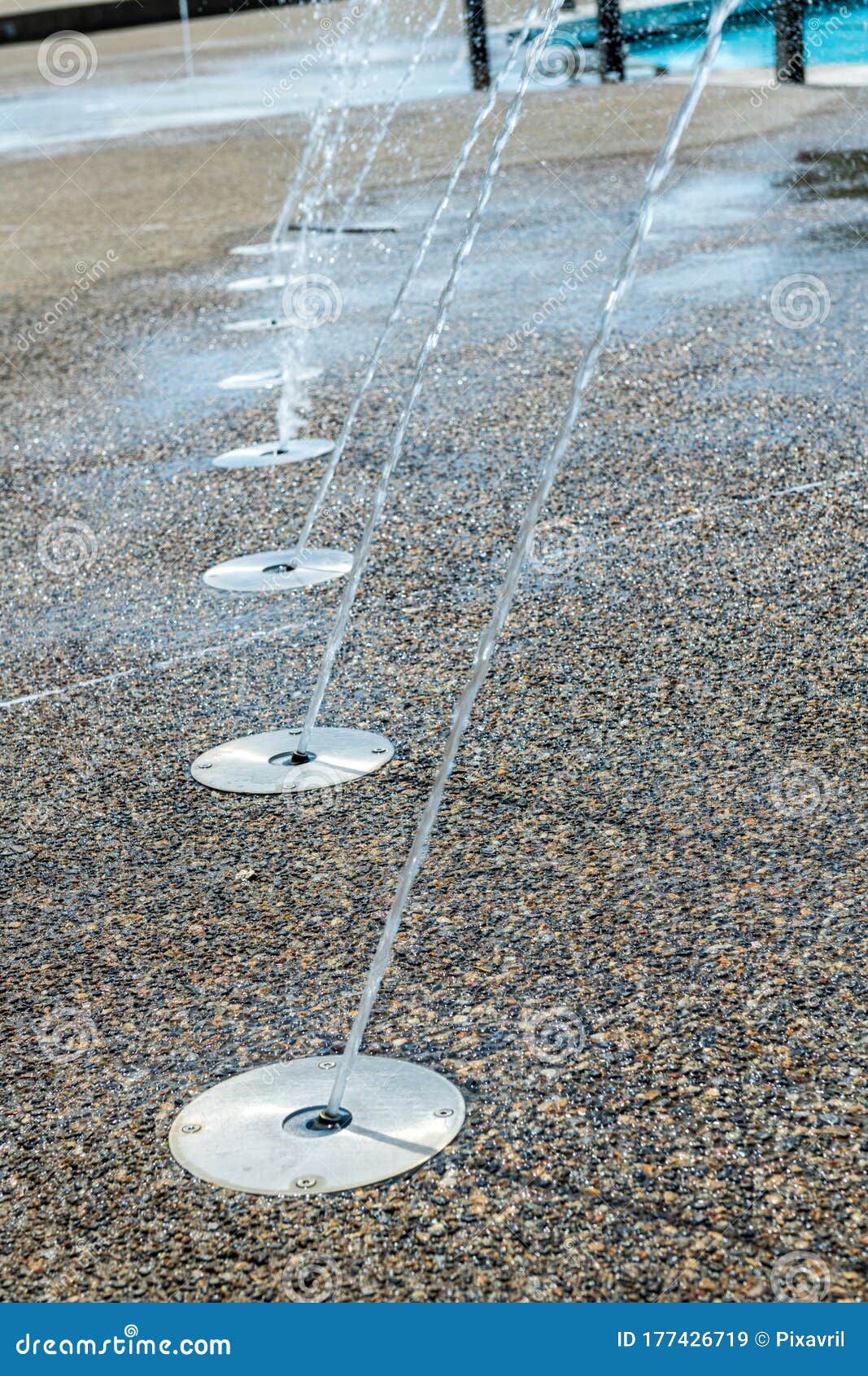 Water jets on the sidewalk stock image. Image of fountain 177426719