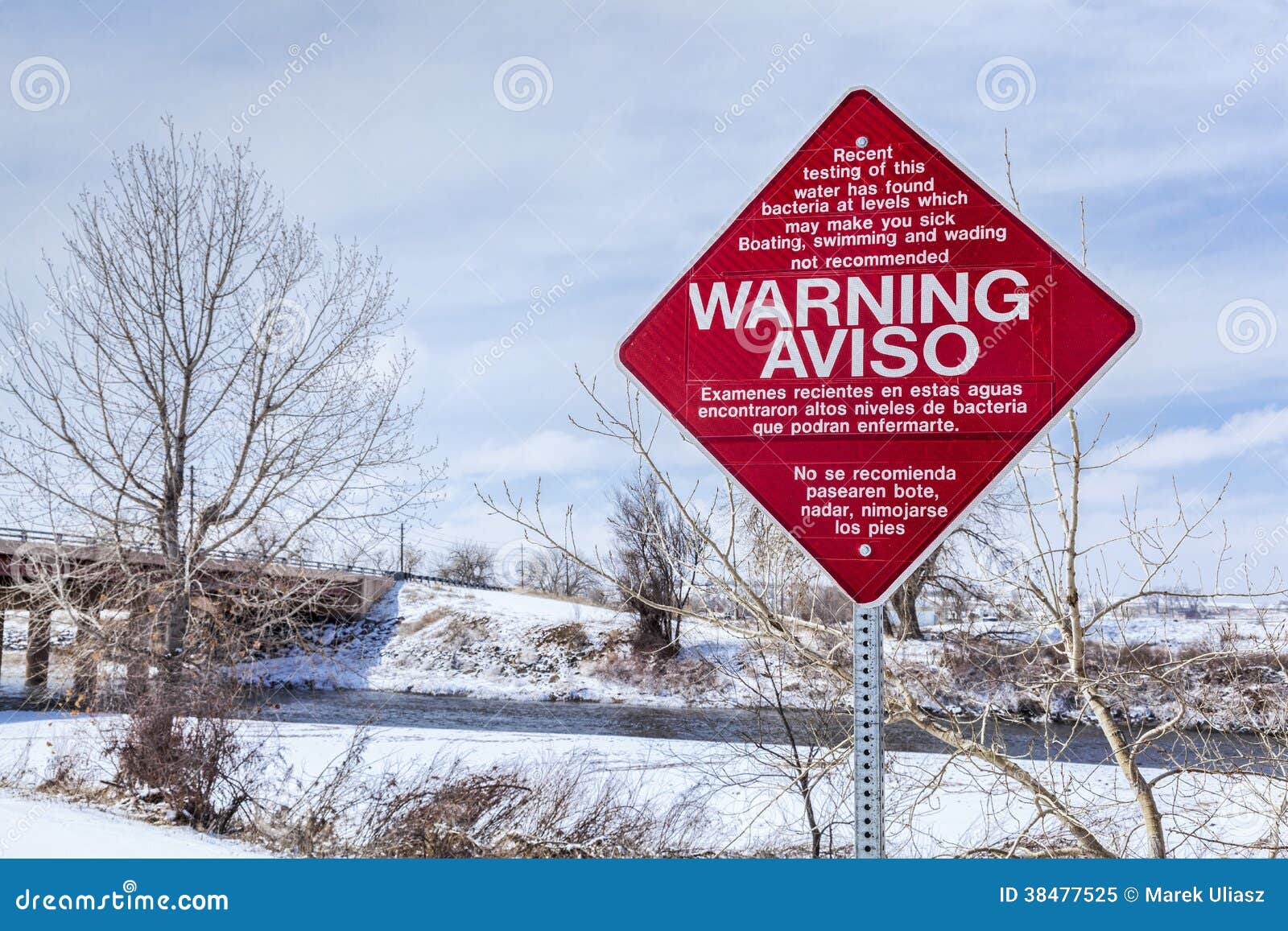 Water pollution warning sign in English and Spanish - South Platte River at Brighton, Colorado