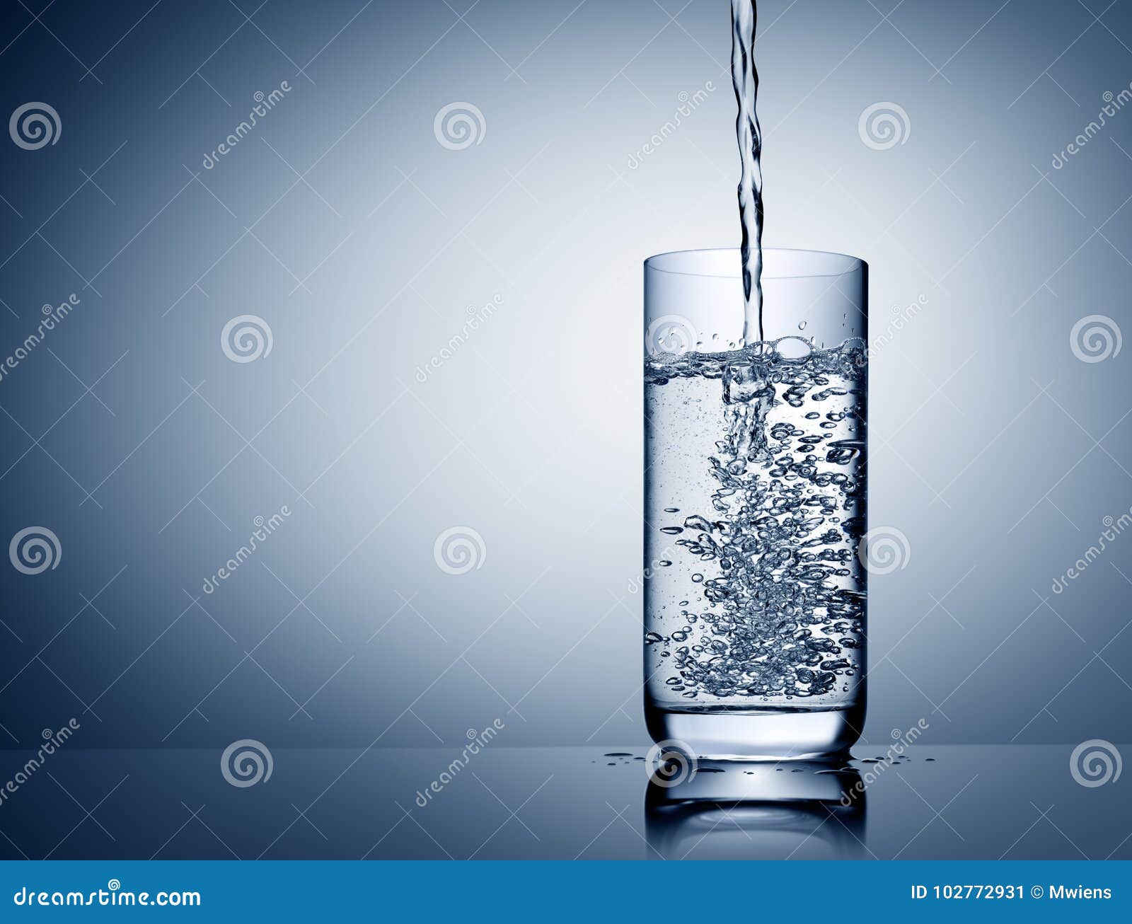 Water Pour into Glass with Bubbles and Reflection on Blue Grey Stock
