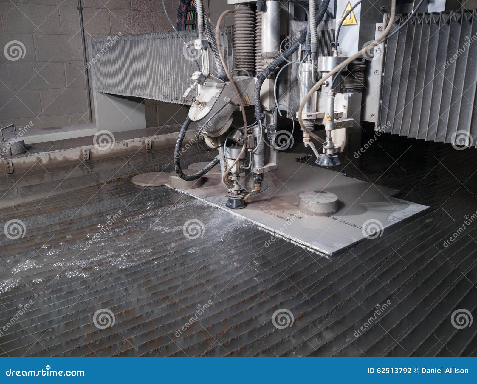 Water Pressure Cutting through Stainless Steel Materials Stock Photo