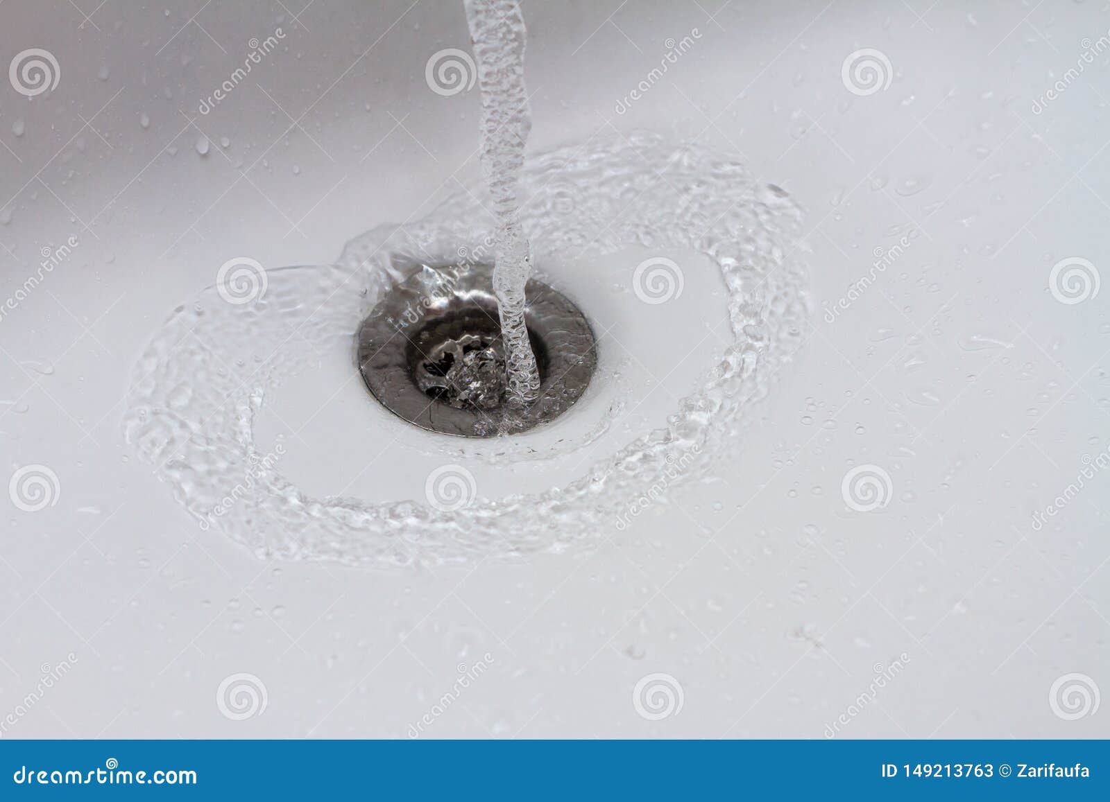 Water Running into Sink Drain Closeup. Drop of Water Falling in Slow