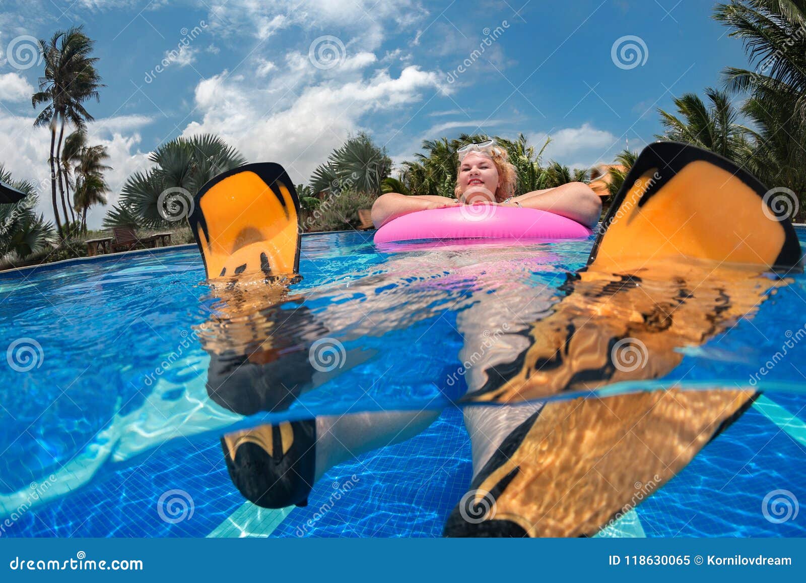 Portrait of plump young woman relaxing in swimming pool - a