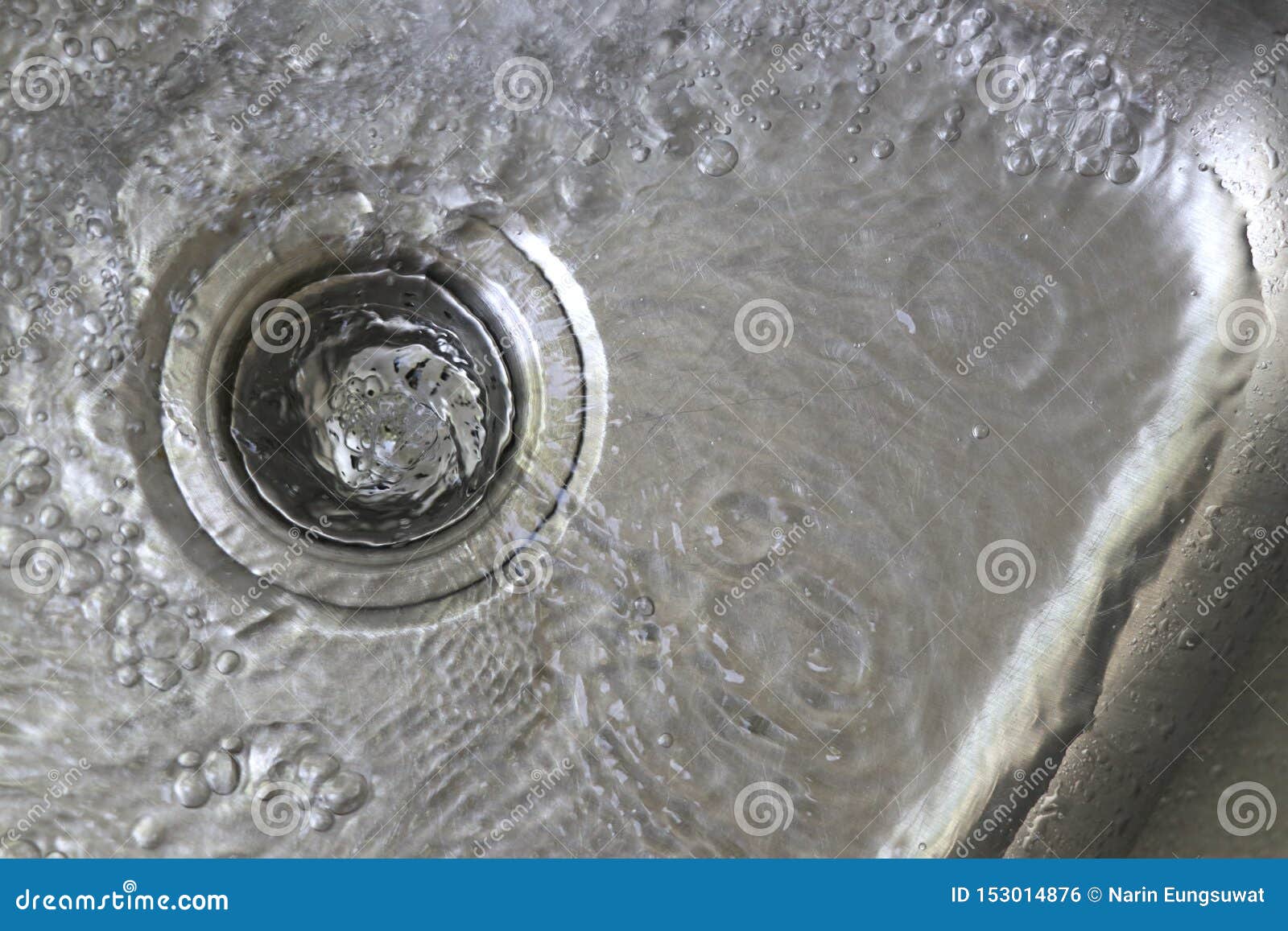 The Water in the Sink is Flowing into the Drain. Stock Photo Image of