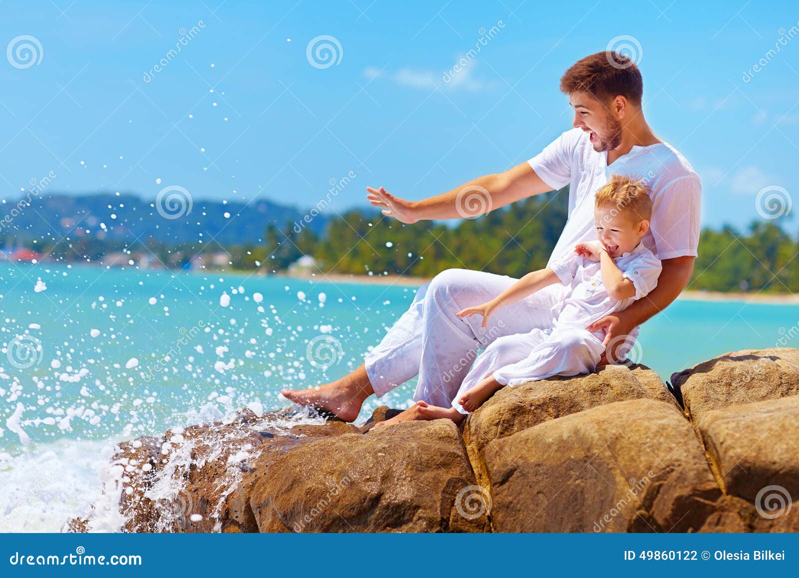 Water Splashing on Happy Father and Son on Vacation Stock Photo Image