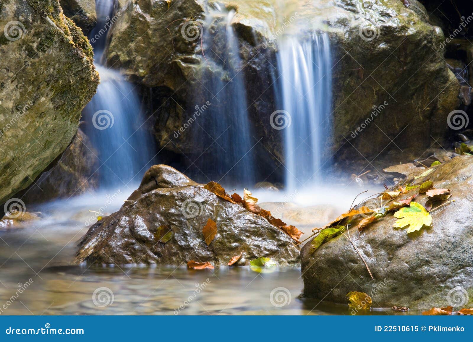 Nice blue water of stream in autumn forest