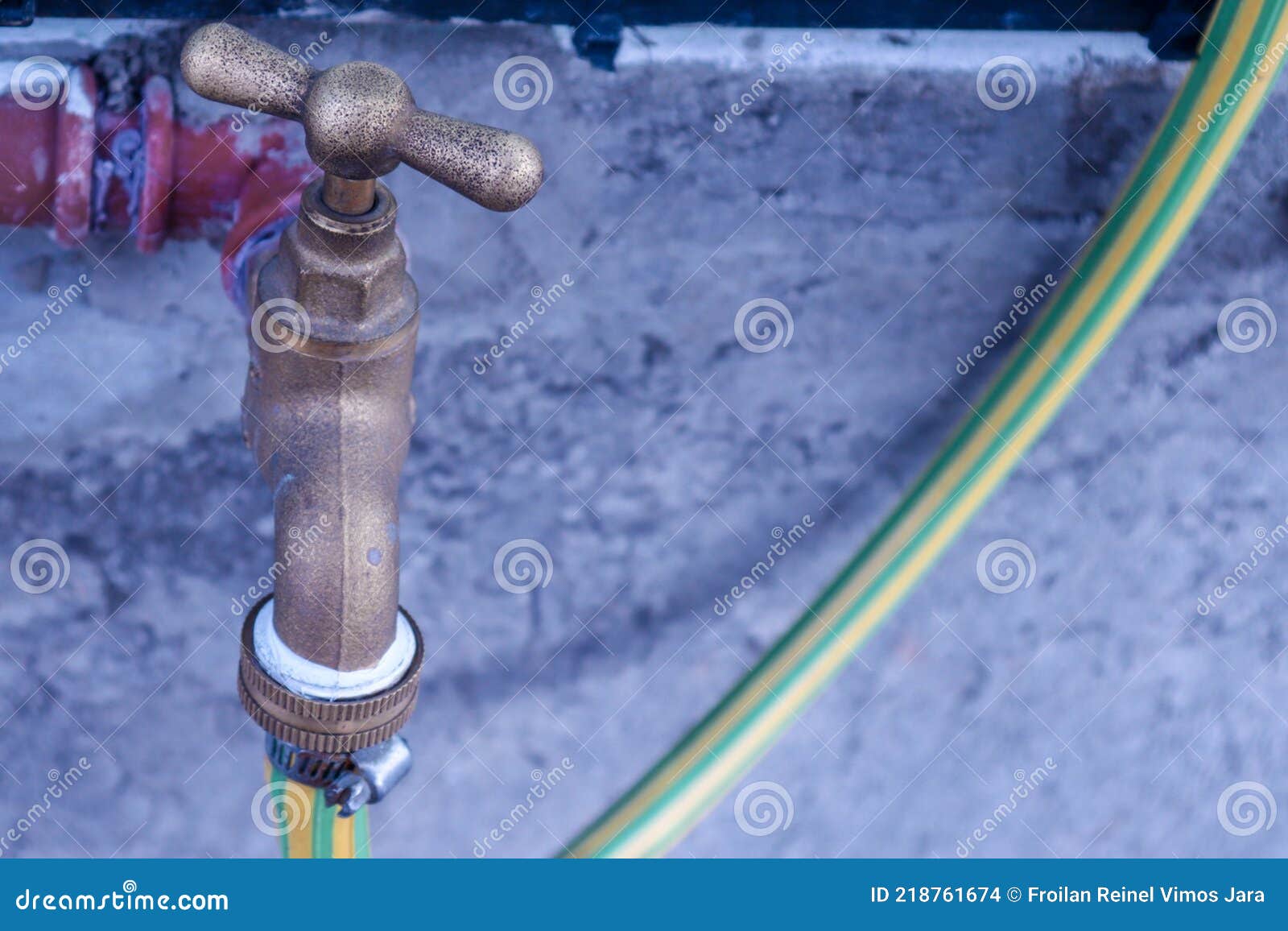 water tap with hose connected for the garden