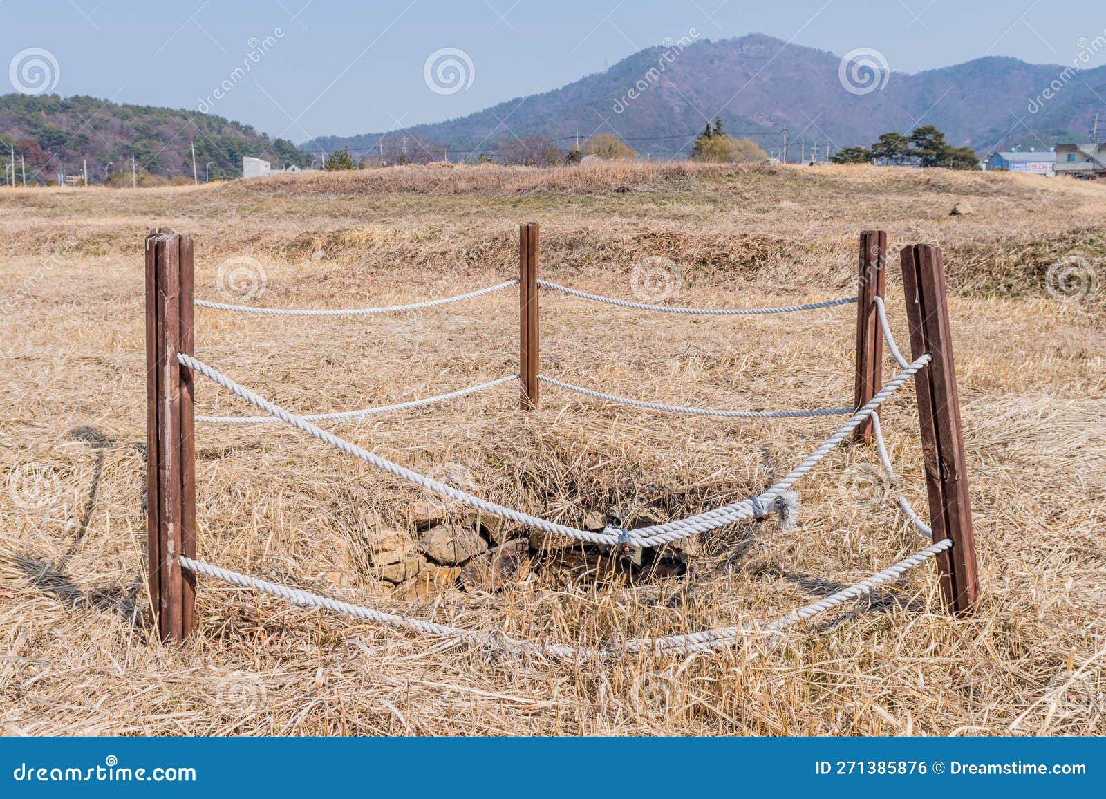 water well cordoned off with wooden beams and rope