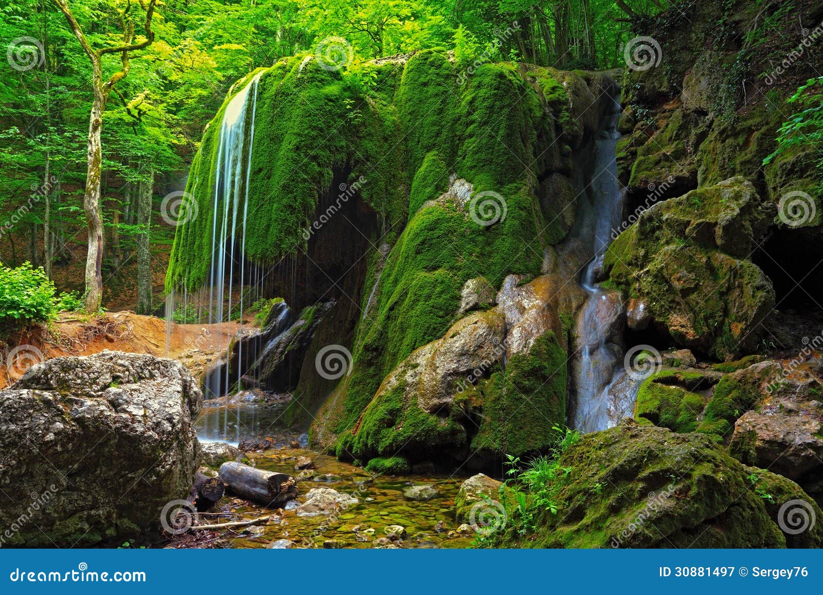 waterfall in crimea forest and wet mossy stone