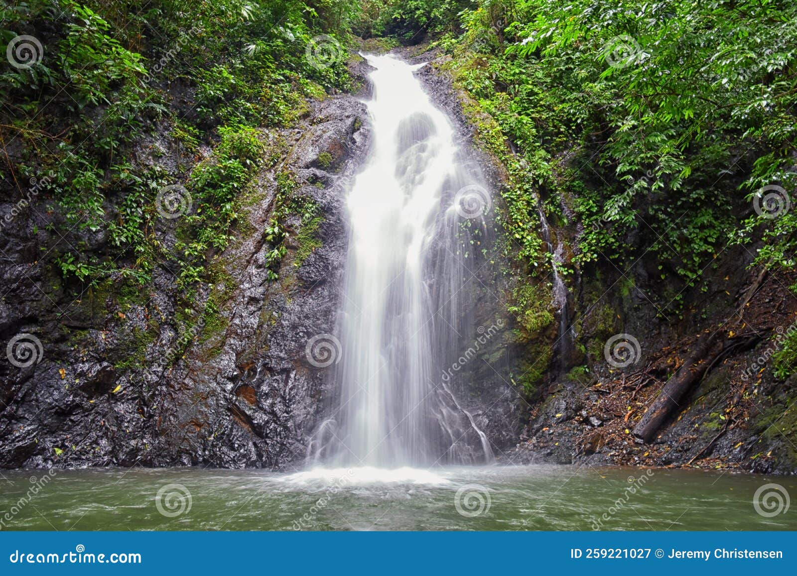waterfall jaco costa rica, catarastas valle encantado - hidden waterfall surrounded by green trees, vegetation, rocks, leaves floa