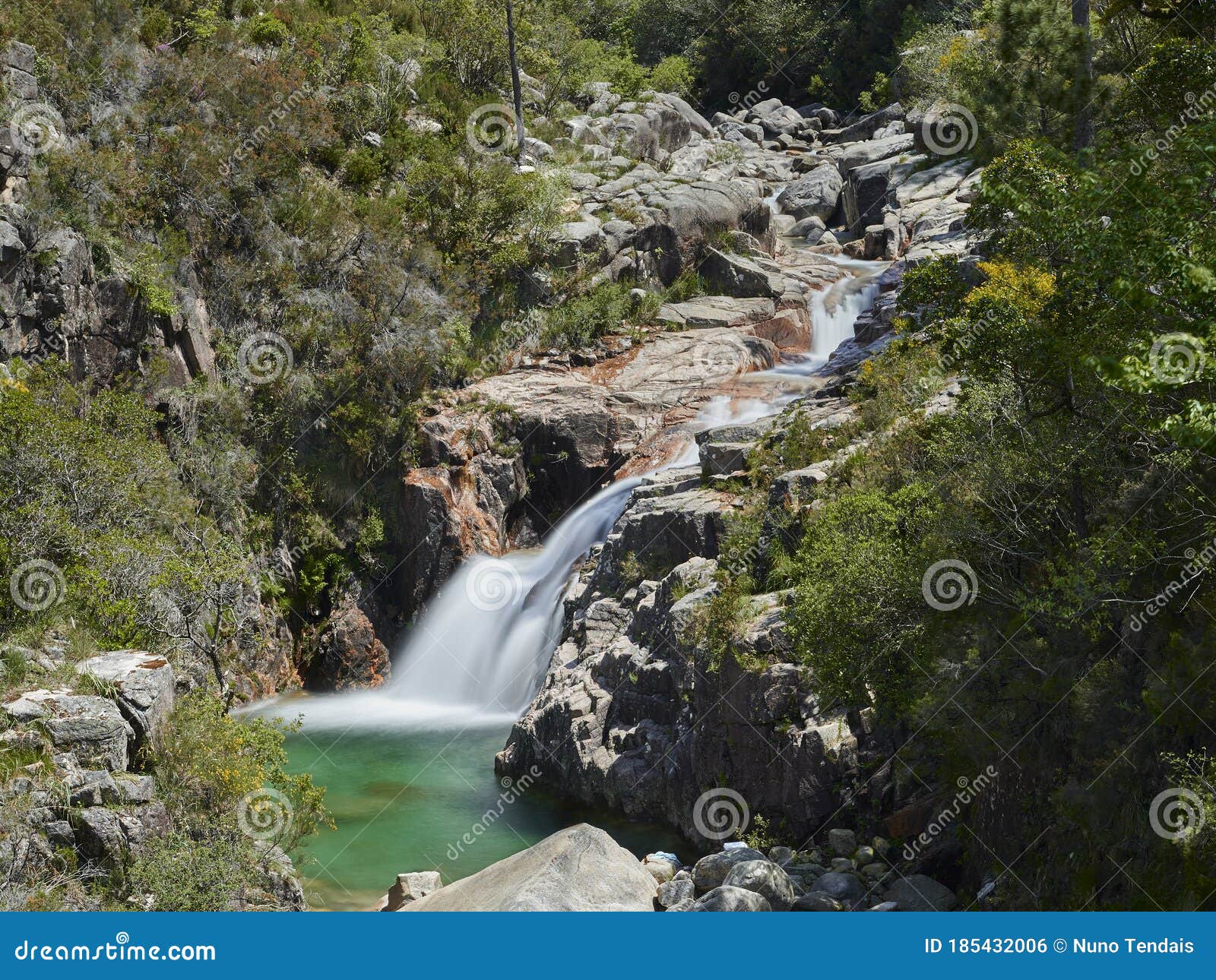 waterfall of portela do homem running to green lake