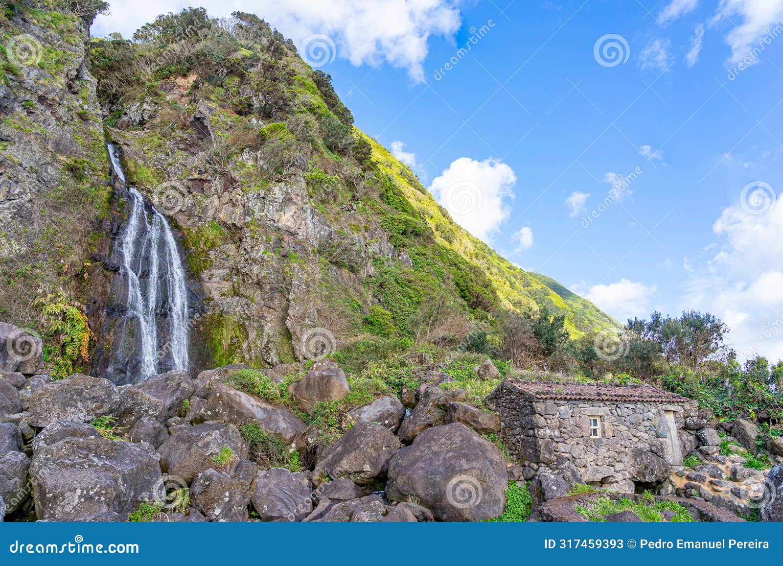 waterfall and small rustic house next to the fajÃ£ dos bodes waterfall-sÃ£o jorge island-azores-portugal.