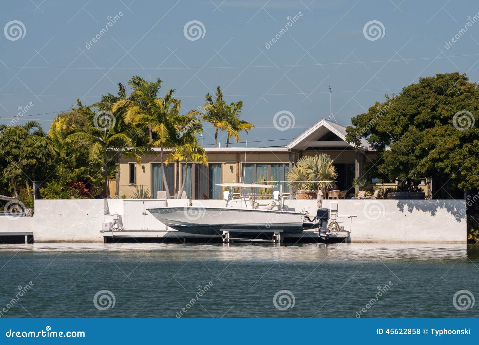 Waterfront villa with boat stock photo. Image of villa 45622858