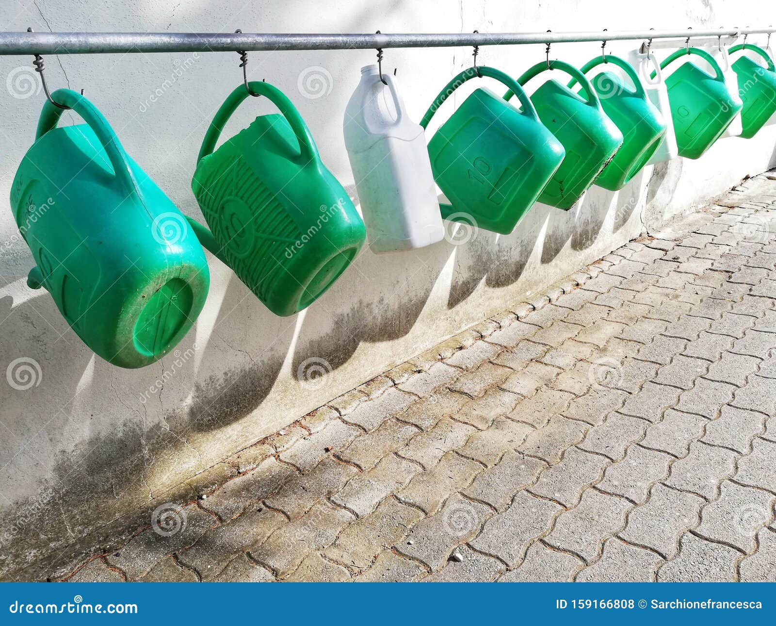 watering cans hanging in a row