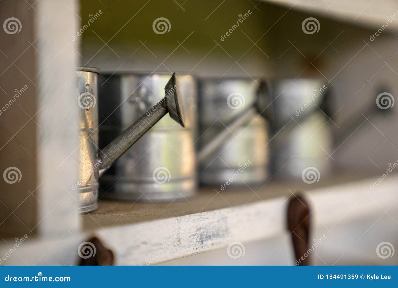Watering Cans Lined Up on a Shelf Stock Image Image of retro