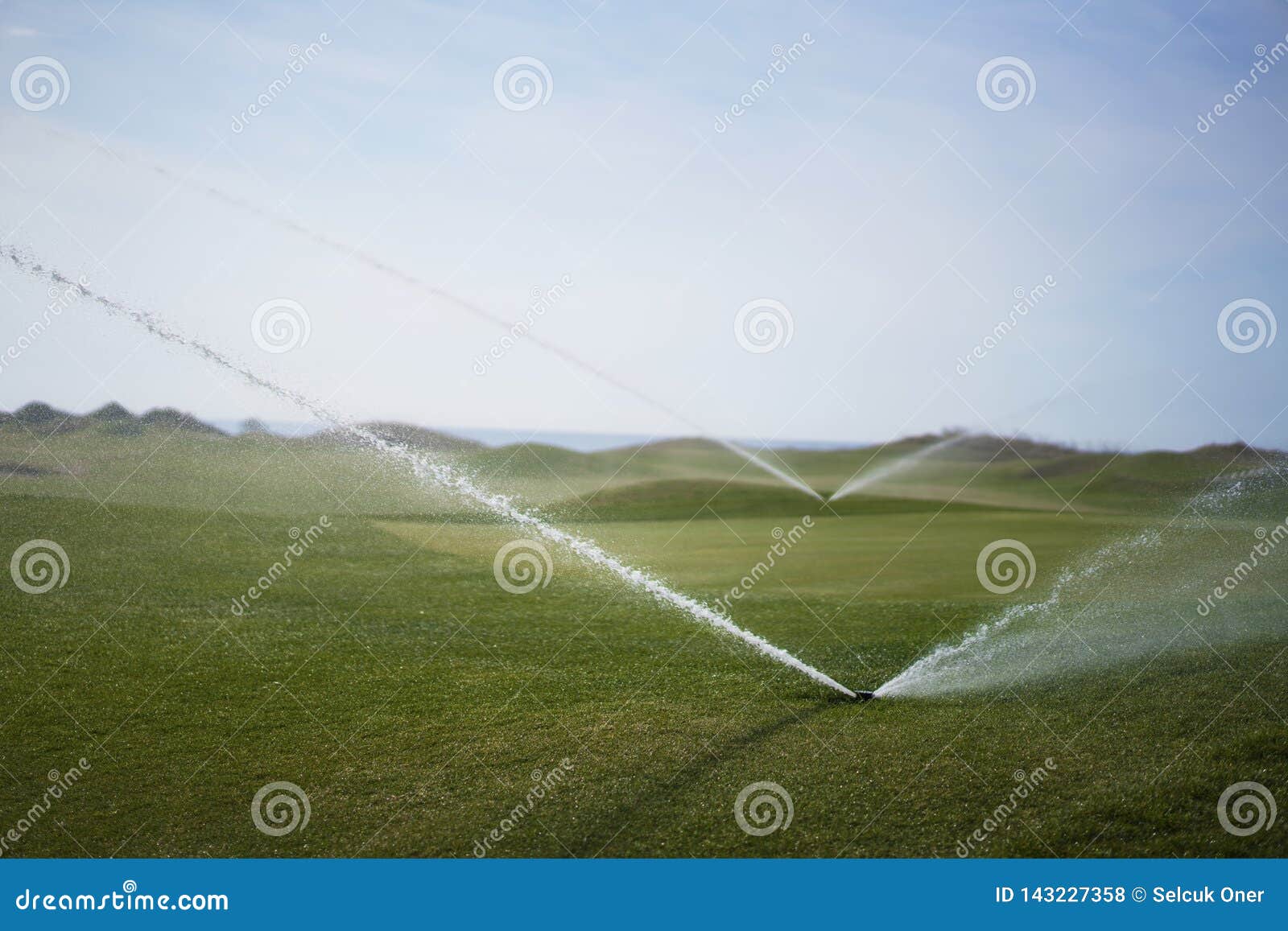 Watering the golf course stock photo. Image of green 143227358