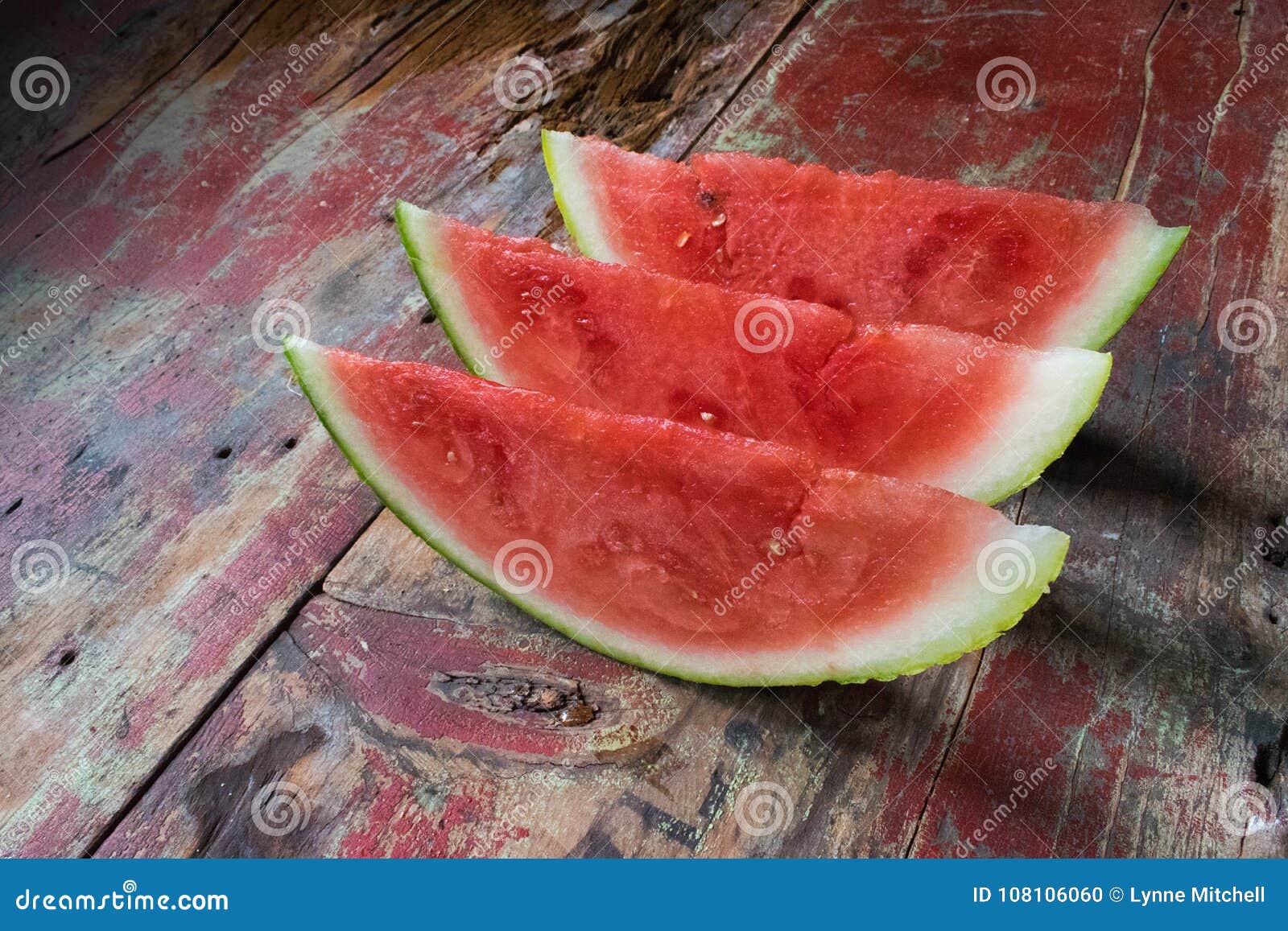 watermelon slices on wooden table in rustic setting