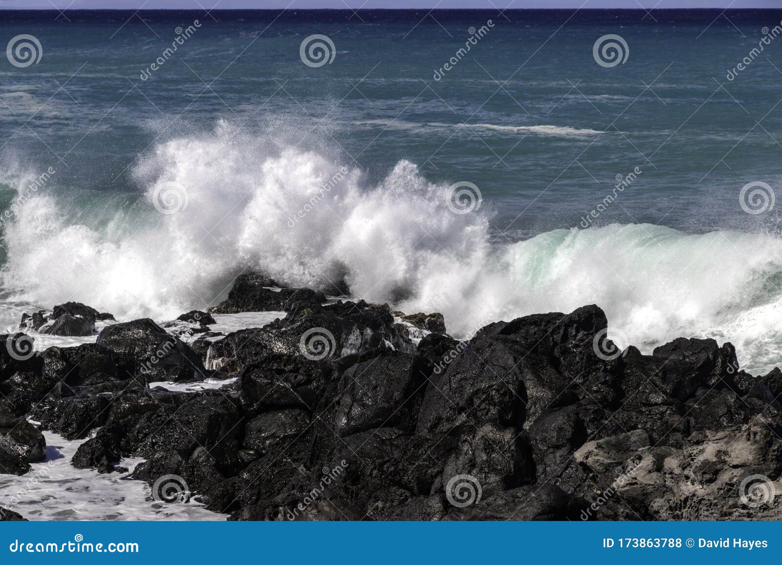 Wave Breaking On Black Volcanic Rocks Hawaiian Coast Blue Green