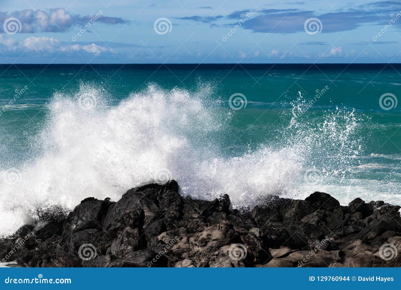 Wave Breaking On Black Lava Rock In Hawaiiwhite Spray In The Air