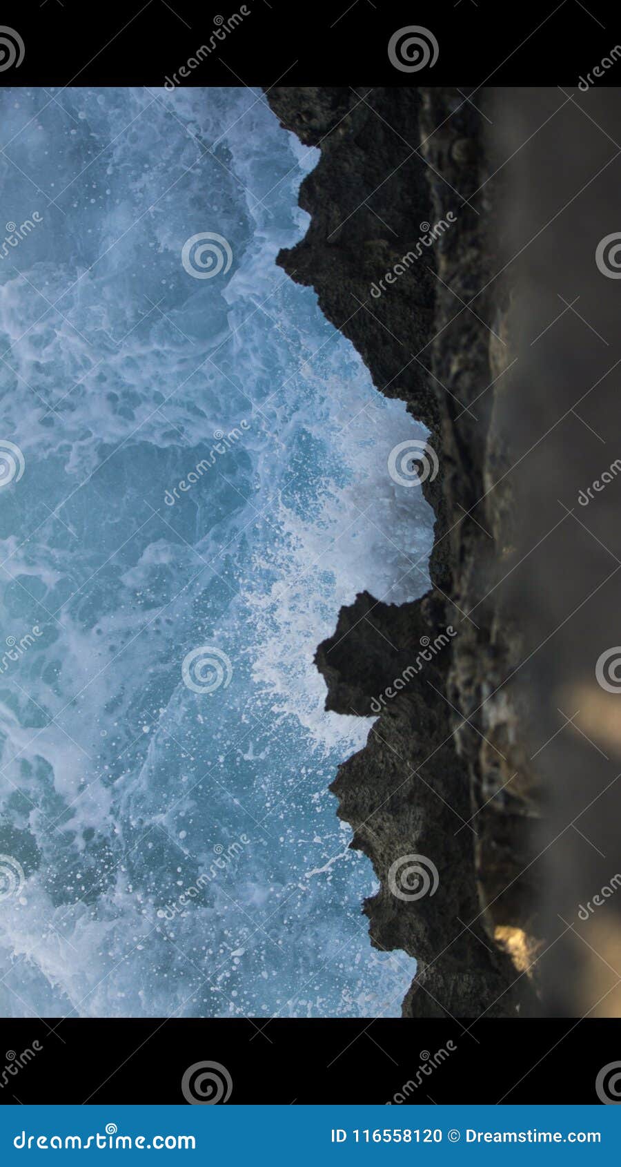 Wave hitting the rocks stock photo. Image of light, wave - 116558120