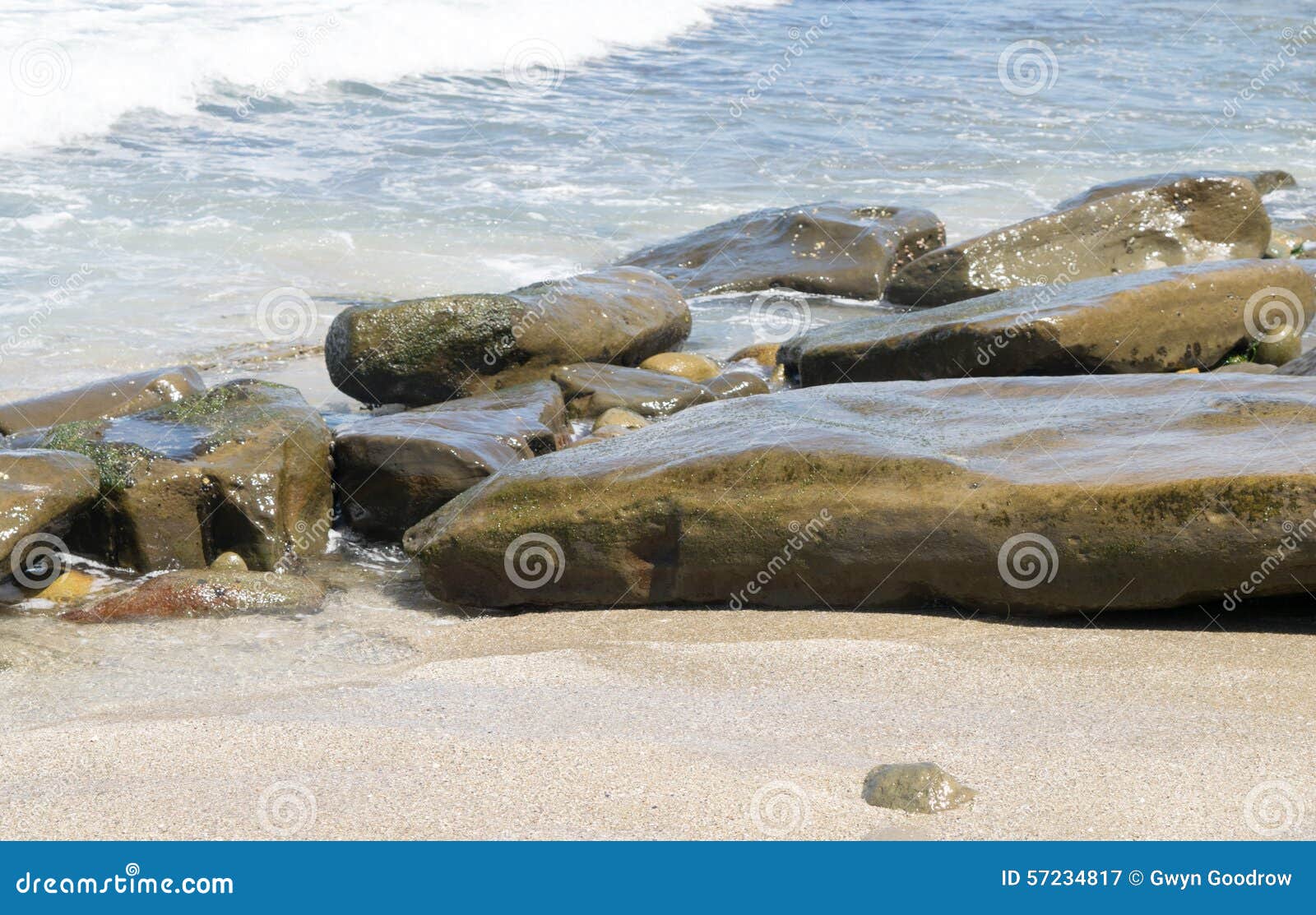 Waves Approaching Sandy Beach With Large Boulders Stock Image Image
