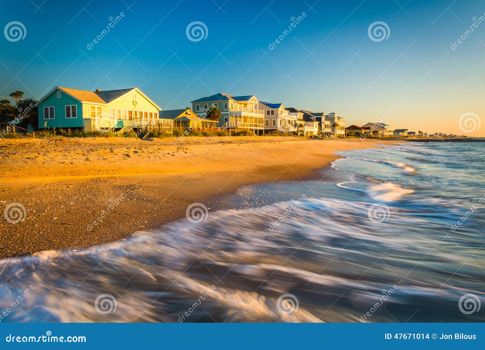waves in the atlantic ocean and morning light on beachfront home