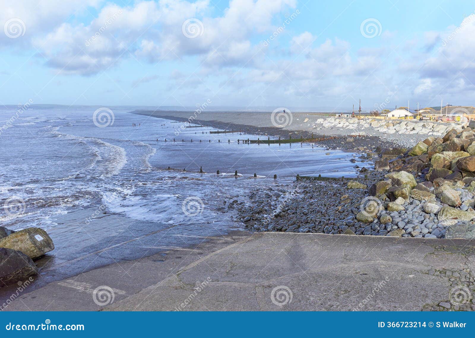 tide heading towards the pebble ridge at westward ho!, north devon, england.