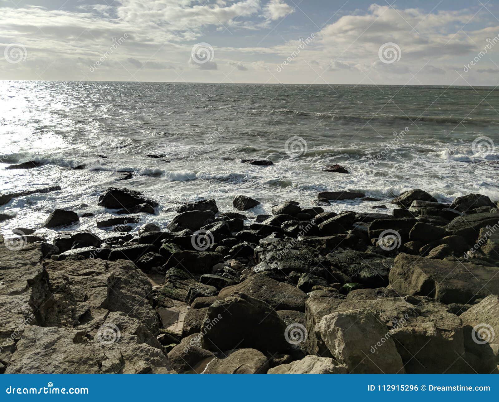 Waves breaking on rocks stock photo. Image of rocks - 112915296
