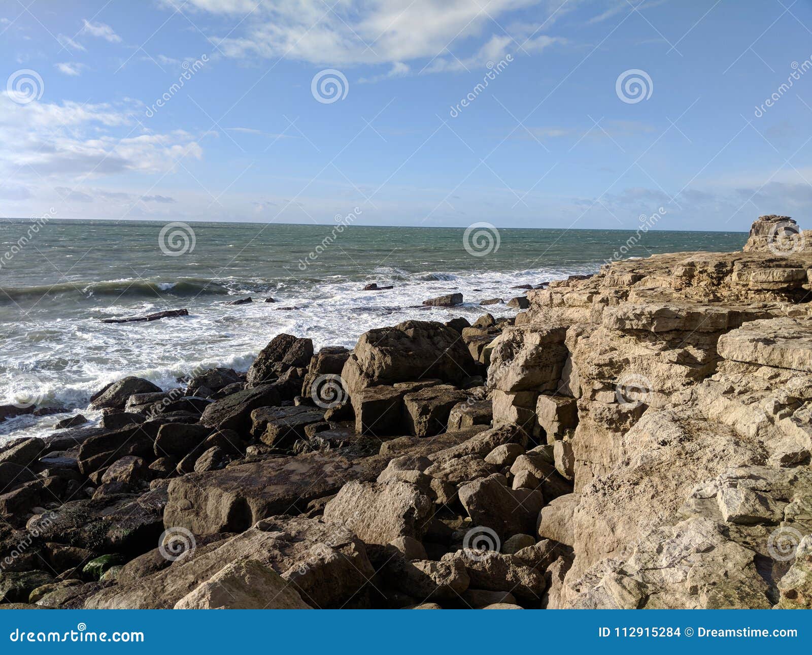 Waves breaking on rocks stock photo. Image of weymouth - 112915284
