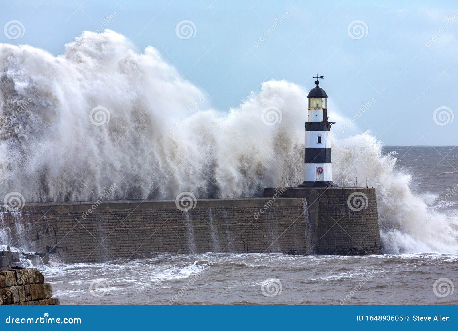 waves crashing over seaham lighthouse - england