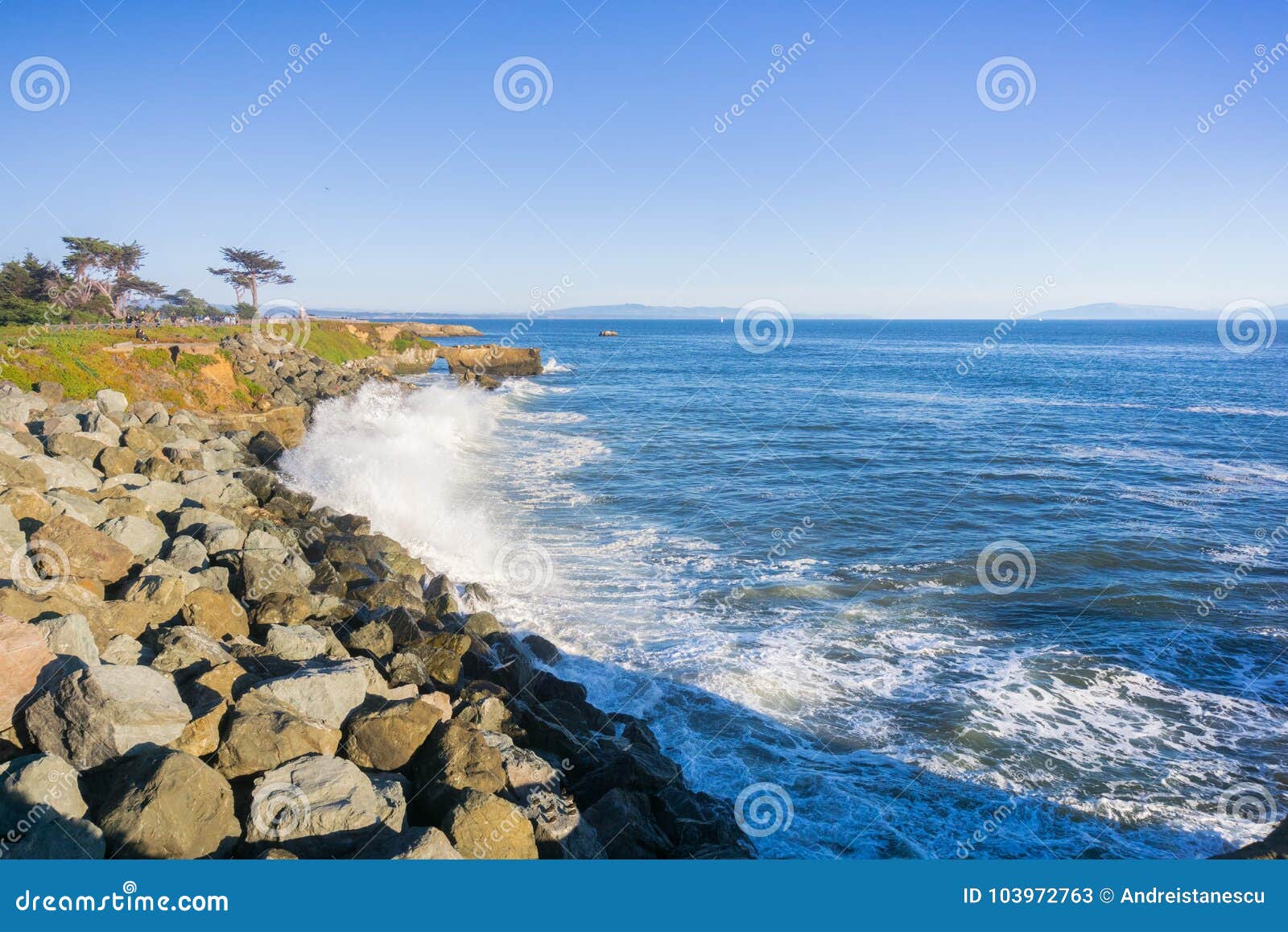 waves crashing on the rocky shoreline of the pacific coast; santa cruz, california