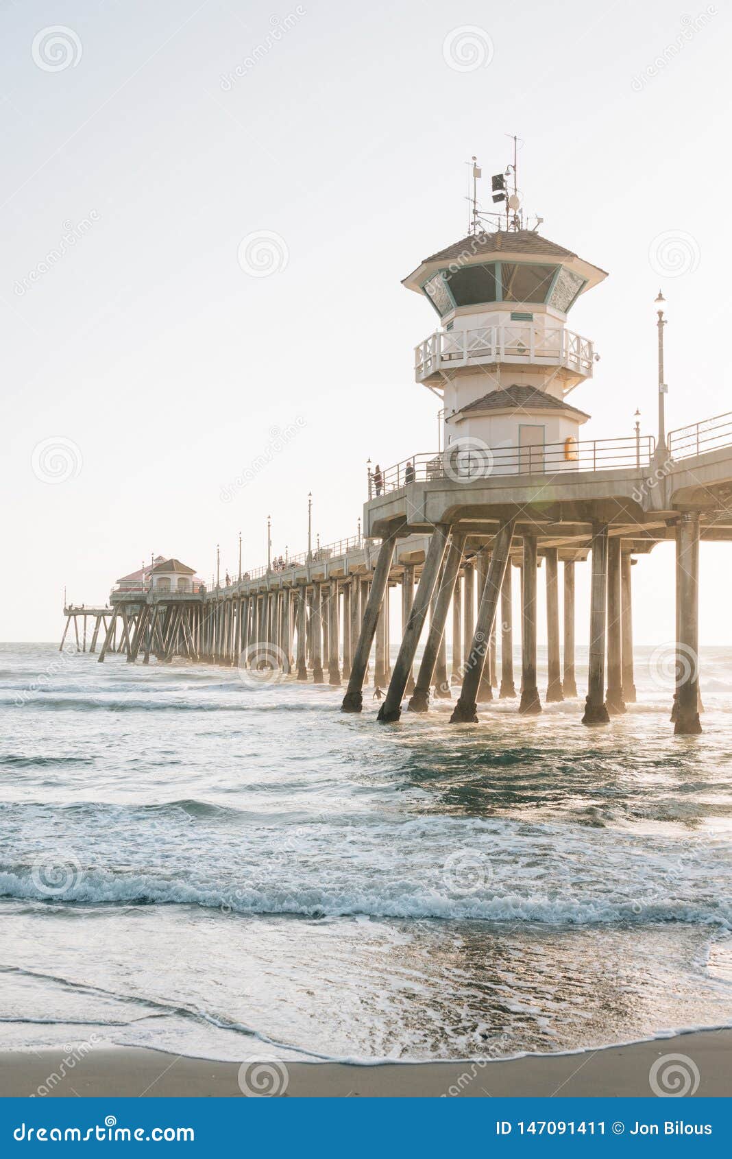 waves in the pacific ocean and the pier in huntington beach, orange county, california