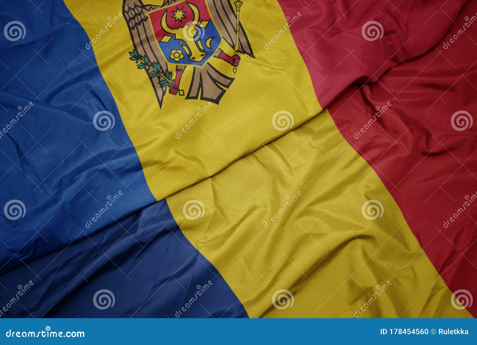waving colorful flag of romania and national flag of moldova