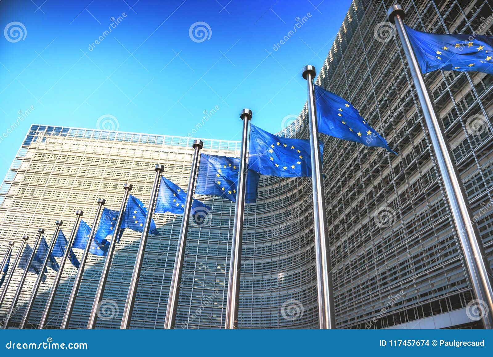 waving eu flags in front of european commission in brussels